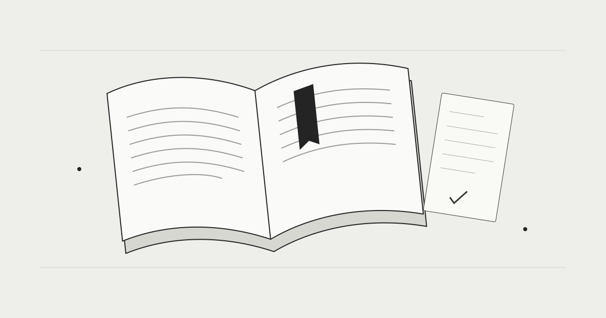 An open book beside a notebook for keeping your place